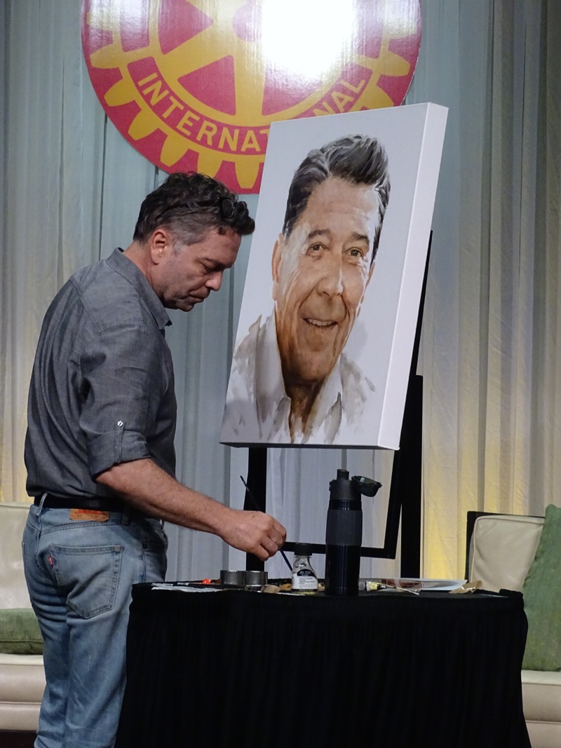 Atlanta Rotarian and portrait painter Ross Rossin paints Ronald Reagan - the portrait was auctioned at the conference for $10,000 - all proceeds went to polio.