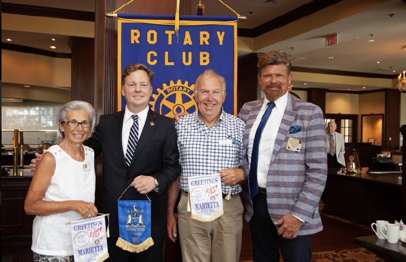 Marietta Rotary President Chris Bethel with visiting UK Rotarians and District Chaplain Mark Barbour